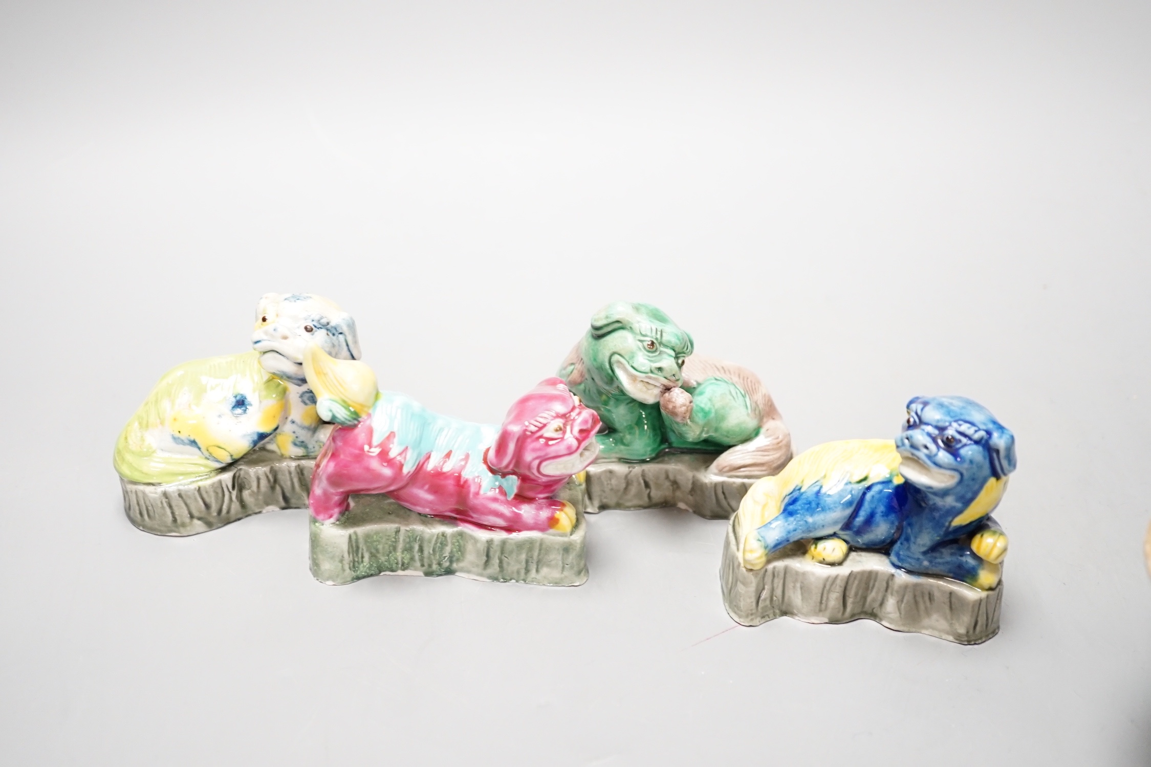 Four Chinese polychrome glazed models of lion-dogs, Republic period and a Chinese famille rose dish, Tongzhi mark, 15.5cm (5)